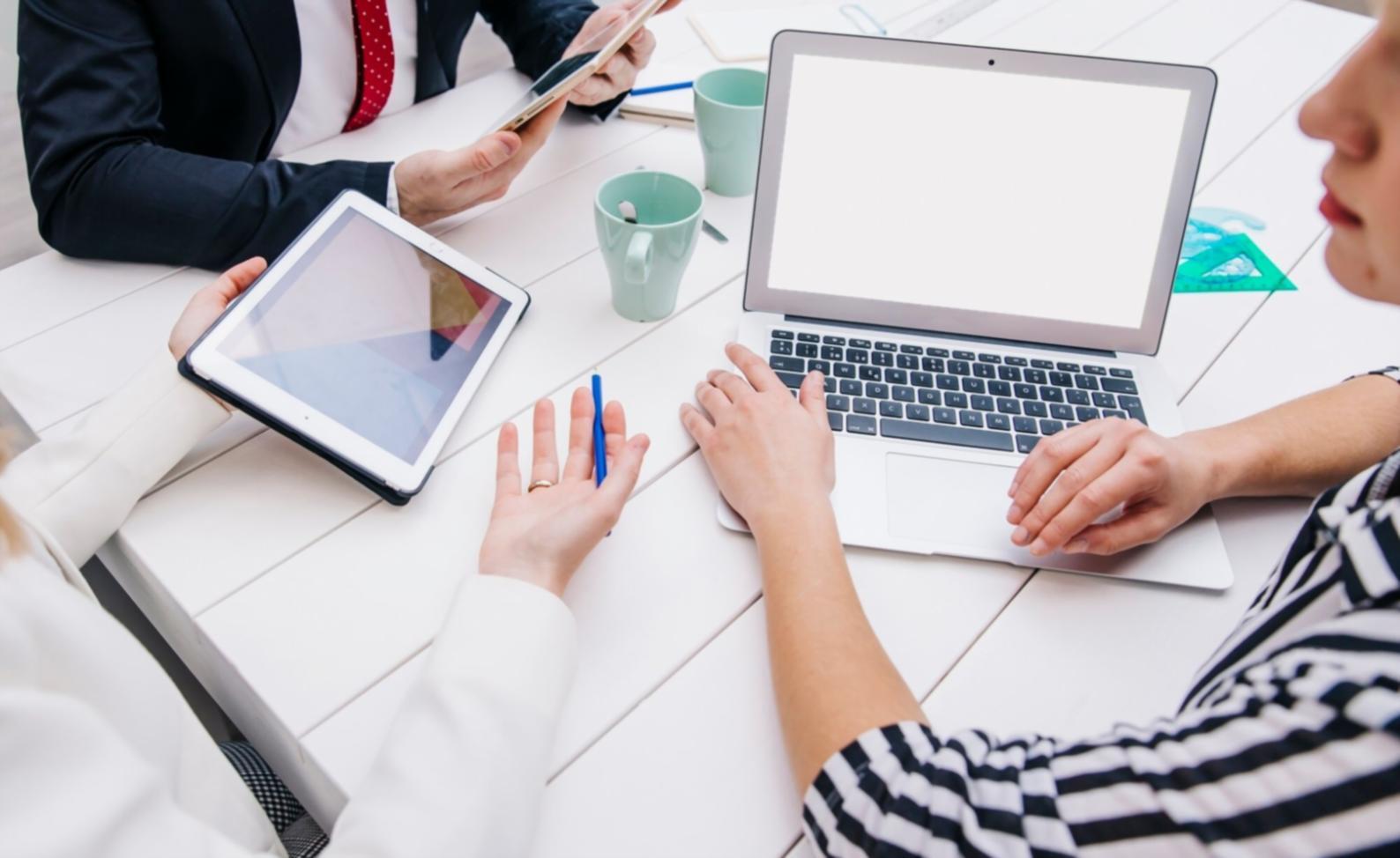 Students collaborating on financial analysis projects in modern learning environment